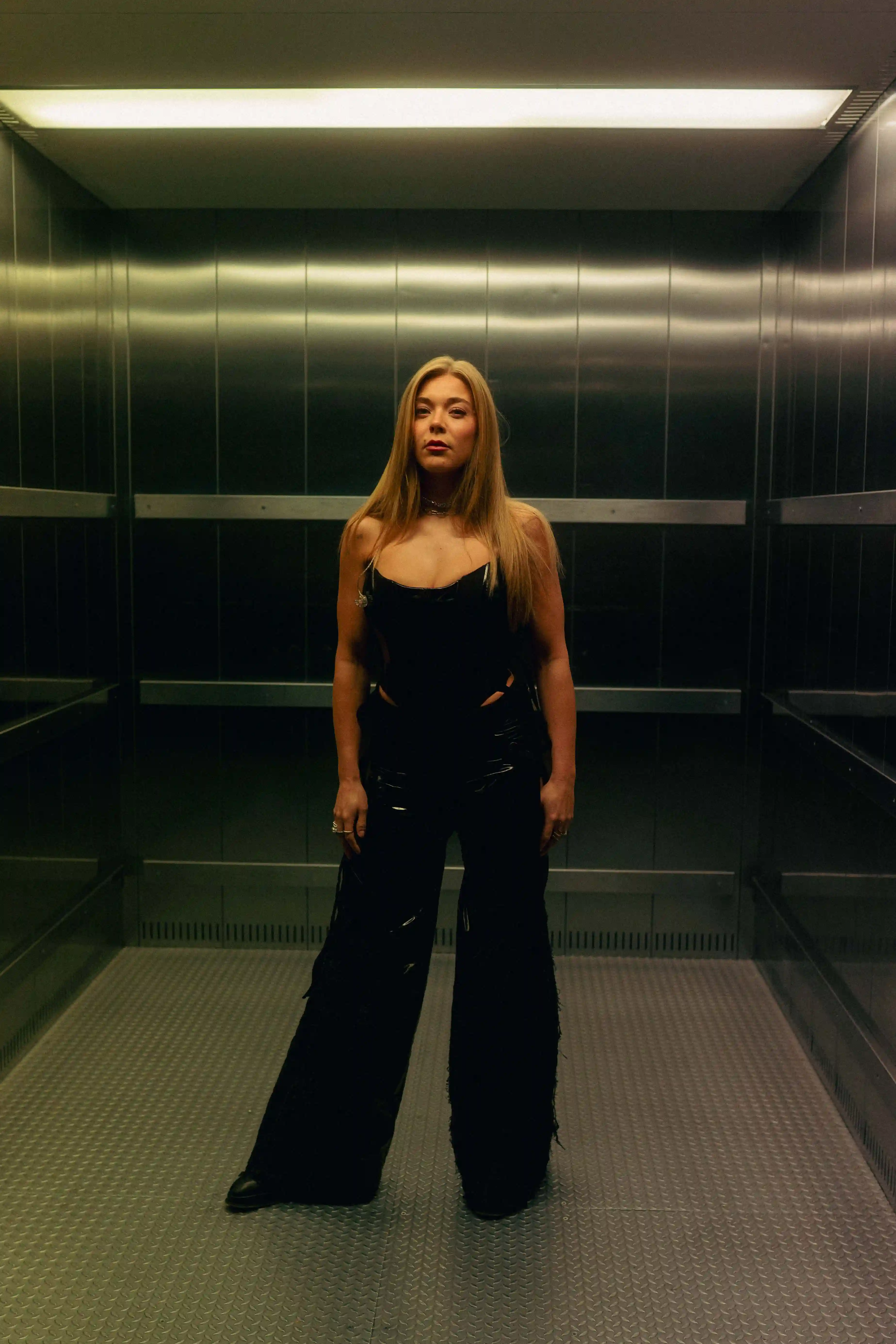 Becky hill full length portrait in a lift